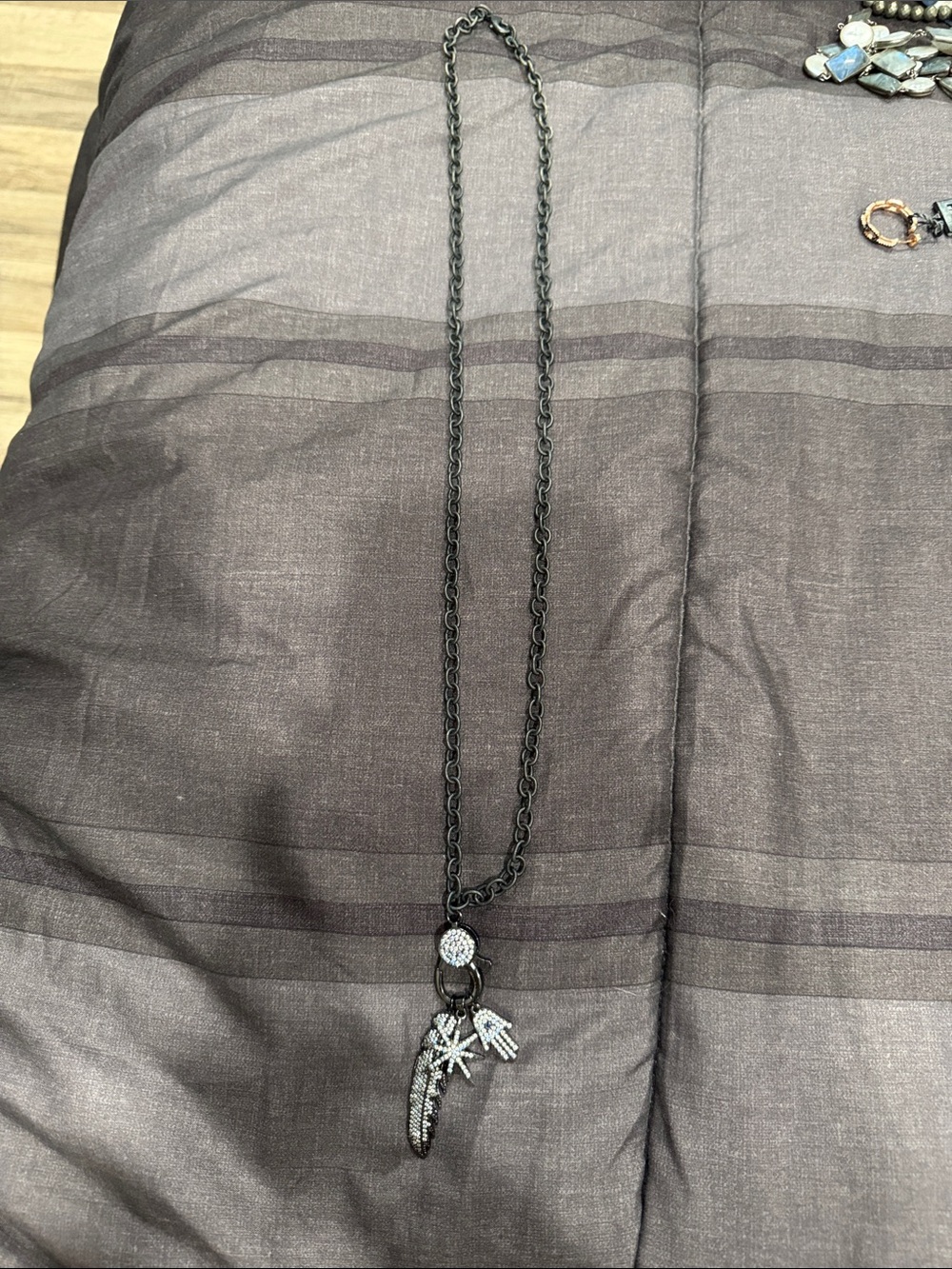 Woman’s Black Pendant Necklace with Feather & Charms